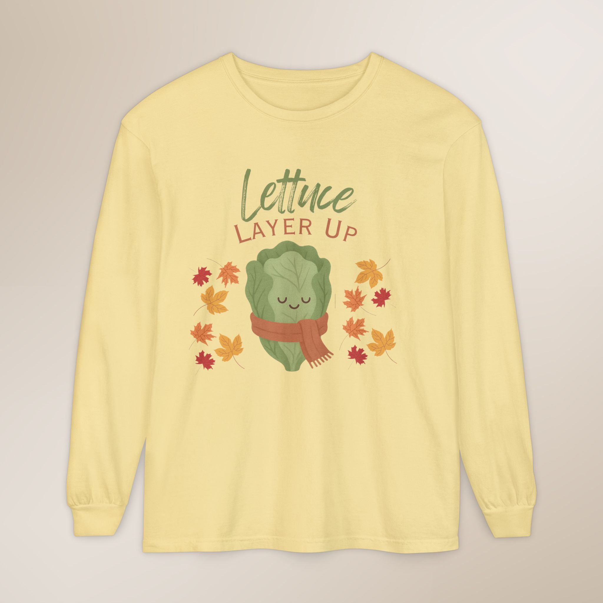 Yellow long-sleeve shirt with a lettuce graphic and 'Lettuce Layer Up' text on a beige background