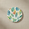 Round coaster with leaf pattern on a white background