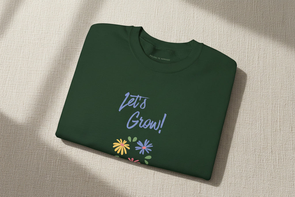 Folded purple shirt with white graphic and text on a white background