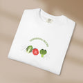 White t-shirt with 'Gardening Rocks' text and vegetable graphics on a beige background