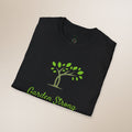 Black t-shirt with green tree and 'Garden Strong' text on a beige background