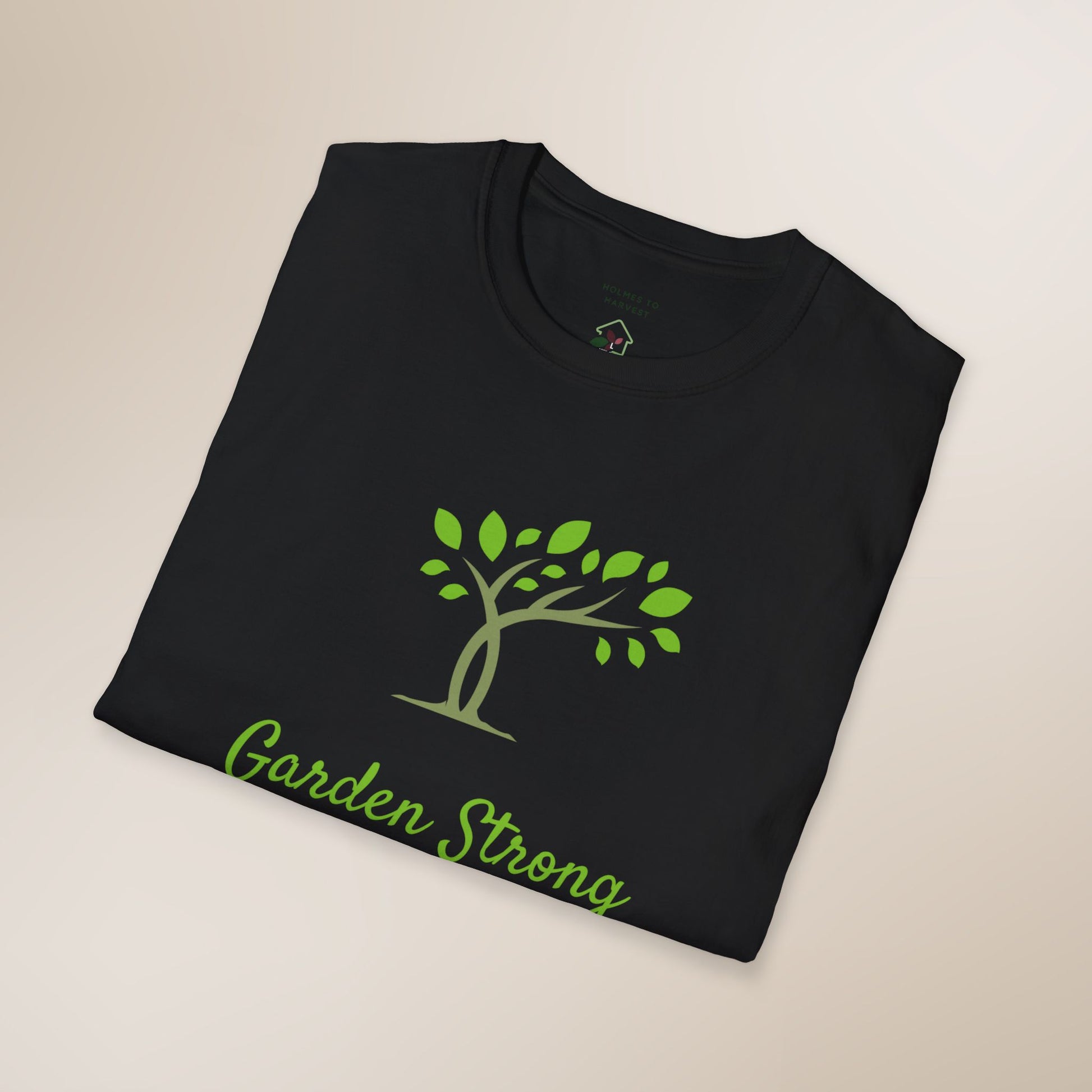 Black t-shirt with green tree and 'Garden Strong' text on a beige background