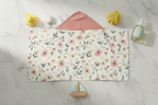 Floral-patterned towel on a marble surface with decorative items.