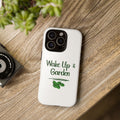 Phone case with 'Wake Up & Garden' text on a wooden surface