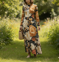 Woman in a floral dress standing in a garden