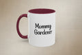 White mug with maroon handle and interior, featuring 'Mommy Gardener' text on a beige background
