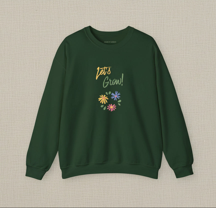 Green sweatshirt with 'Let's Grow!' text and floral designs on a white background