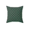 Green pillow with white polka dots on a white background