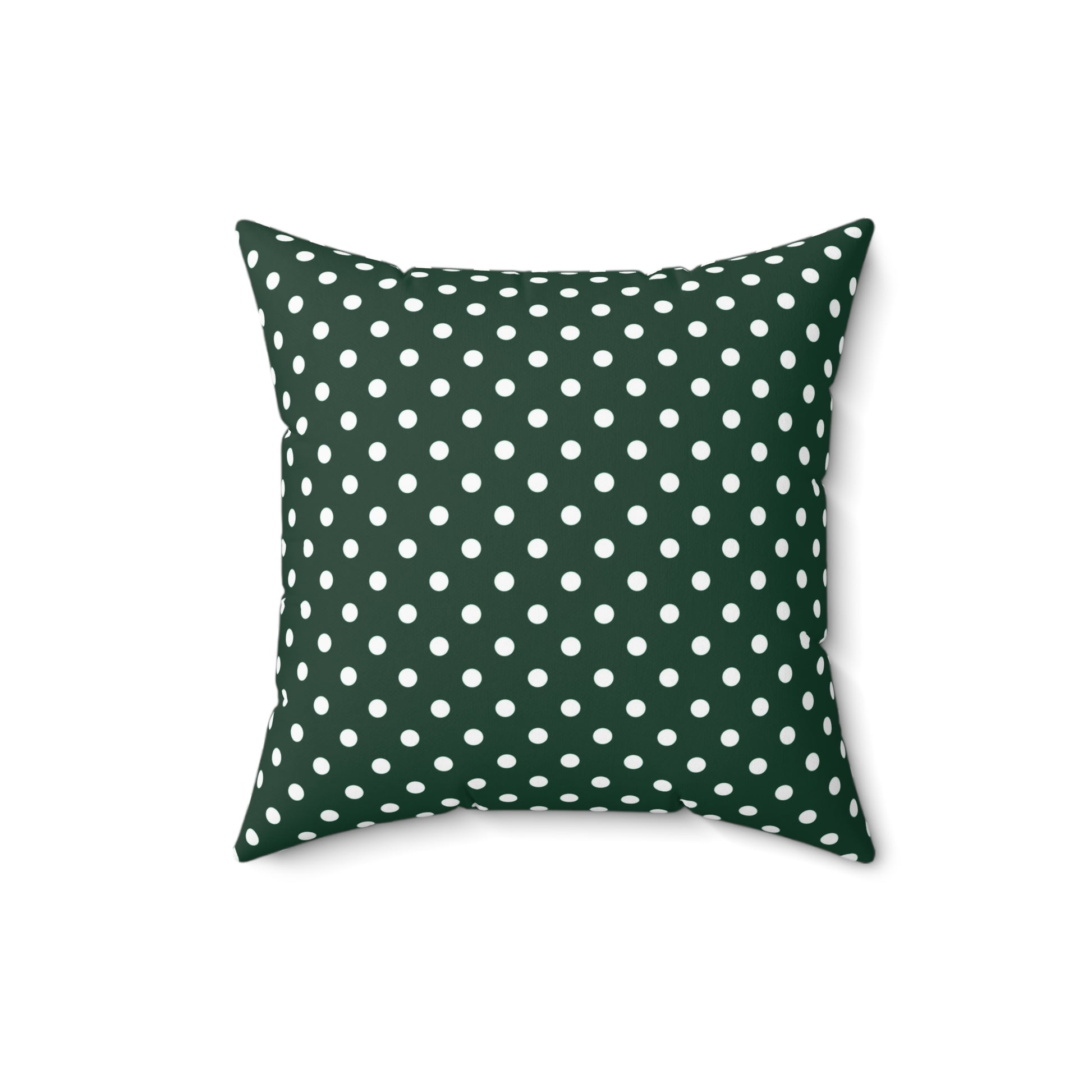 Green pillow with white polka dots on a white background