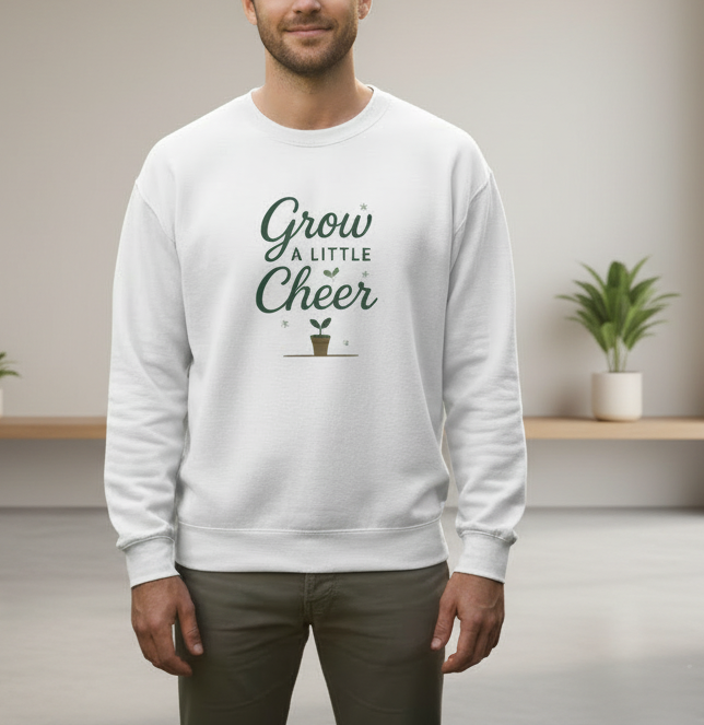 Person wearing a white sweatshirt with 'Grow a Little Cheer' text and plant graphic.