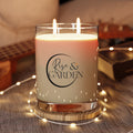 Candle with 'Rise & Garden' label on a decorative surface with lights