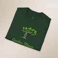 Folded green t-shirt with a tree and 'Garden Strong' text on a beige background
