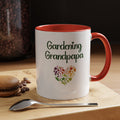White mug with red interior and handle, featuring 'Gardening Grandpapa' text and a heart-shaped leaf design on a wooden surface with coffee beans and a spoon.