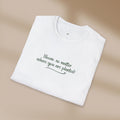 White t-shirt with text on a beige background