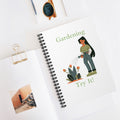 Notebook with gardening-themed illustration and text on a white surface