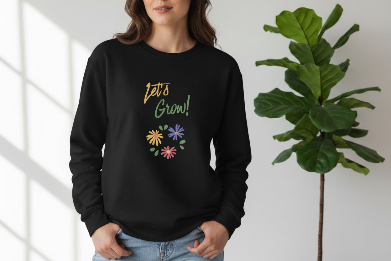 Black sweatshirt with 'Let's Grow!' text and colorful flowers on a white background