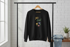 Black sweatshirt with 'Let's Grow!' text and floral designs on a hanger against a white brick wall.