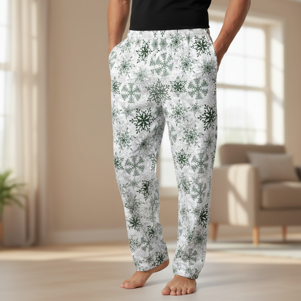 Man in pajama pants reading a book in a cozy living room with a fireplace.