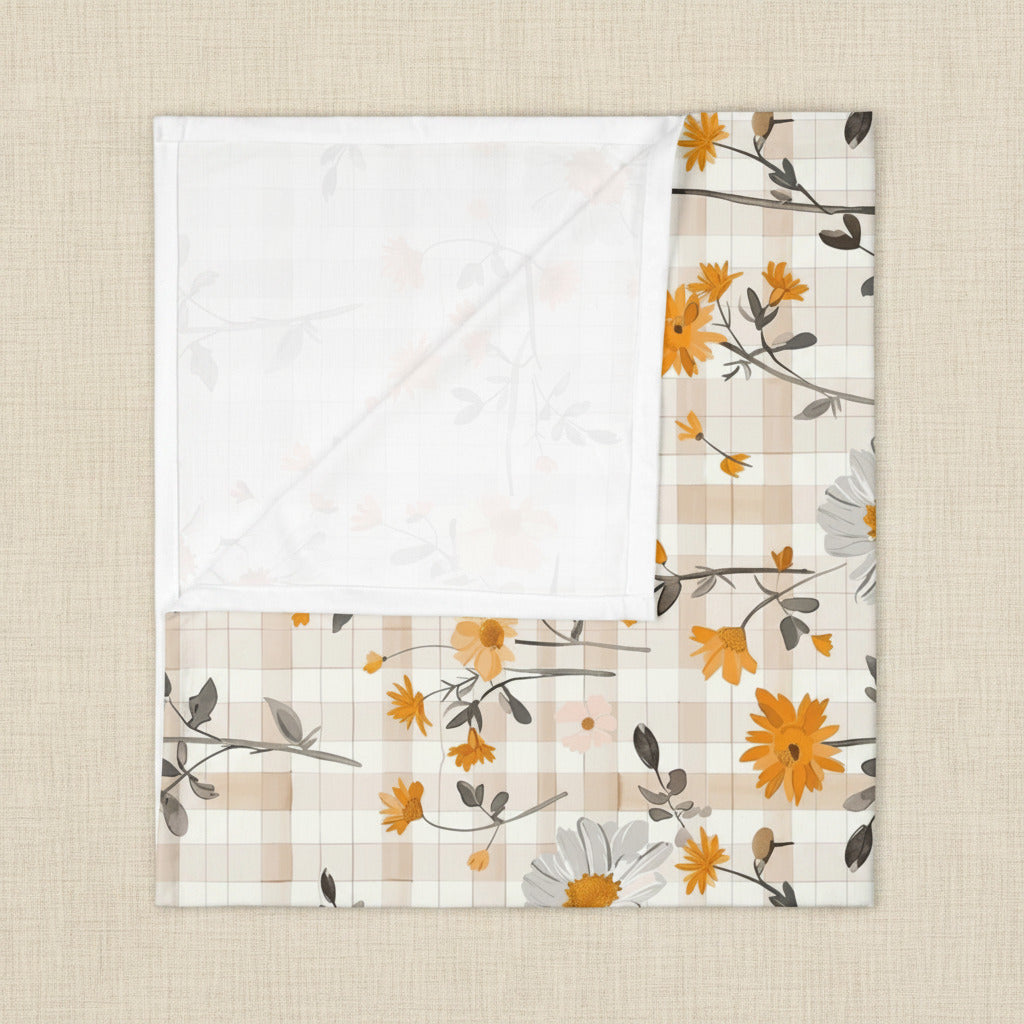 Floral and plaid patterned fabric on a white background