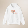 White hoodie with a tree graphic and text on a beige background