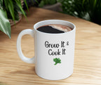 White mug with 'Grow It & Cook It' text and a leaf graphic on a wooden surface.
