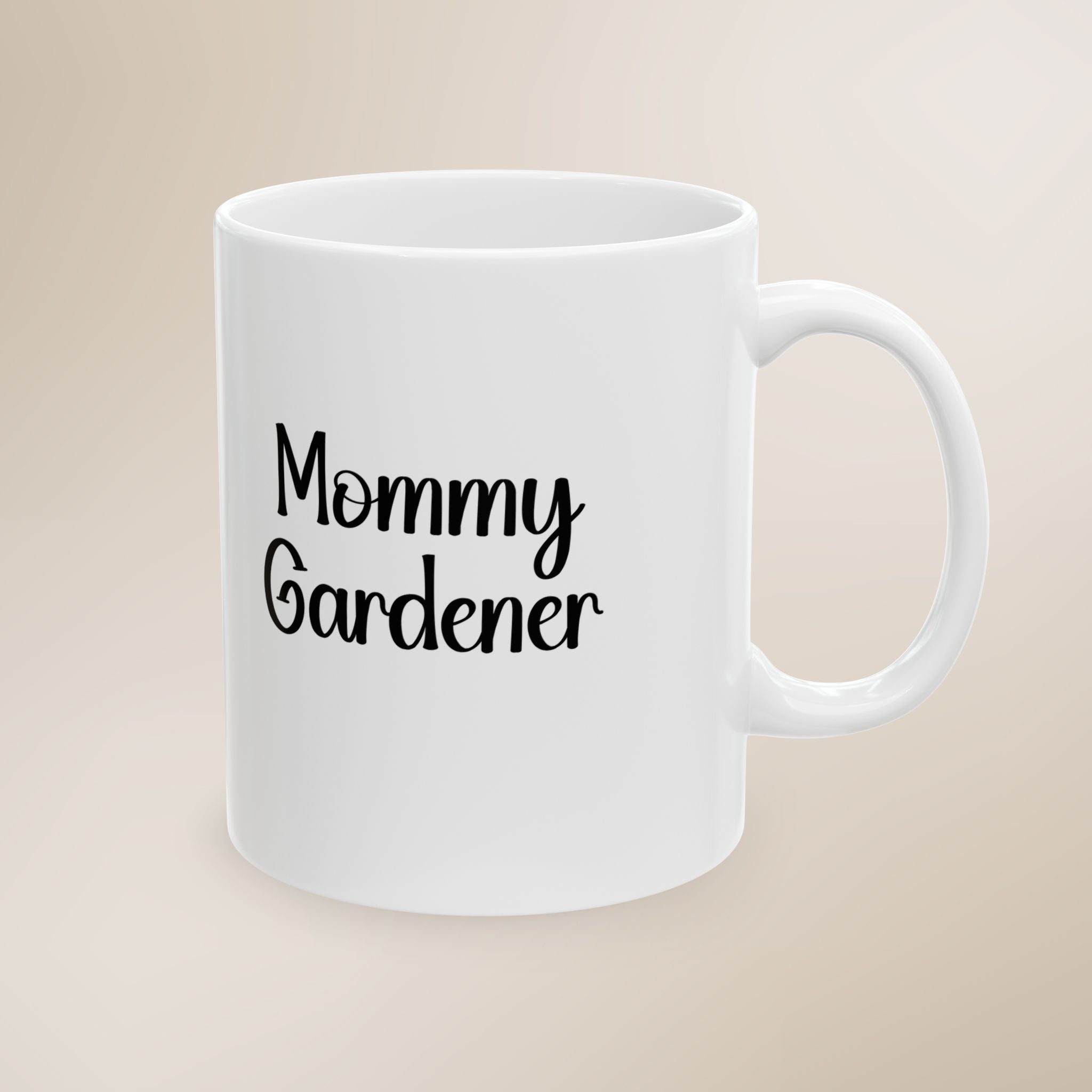 White mug with 'Mommy Gardener' text on a beige background