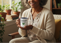 Woman holding a mug with 'Grandma Gardener' text in a cozy indoor setting.