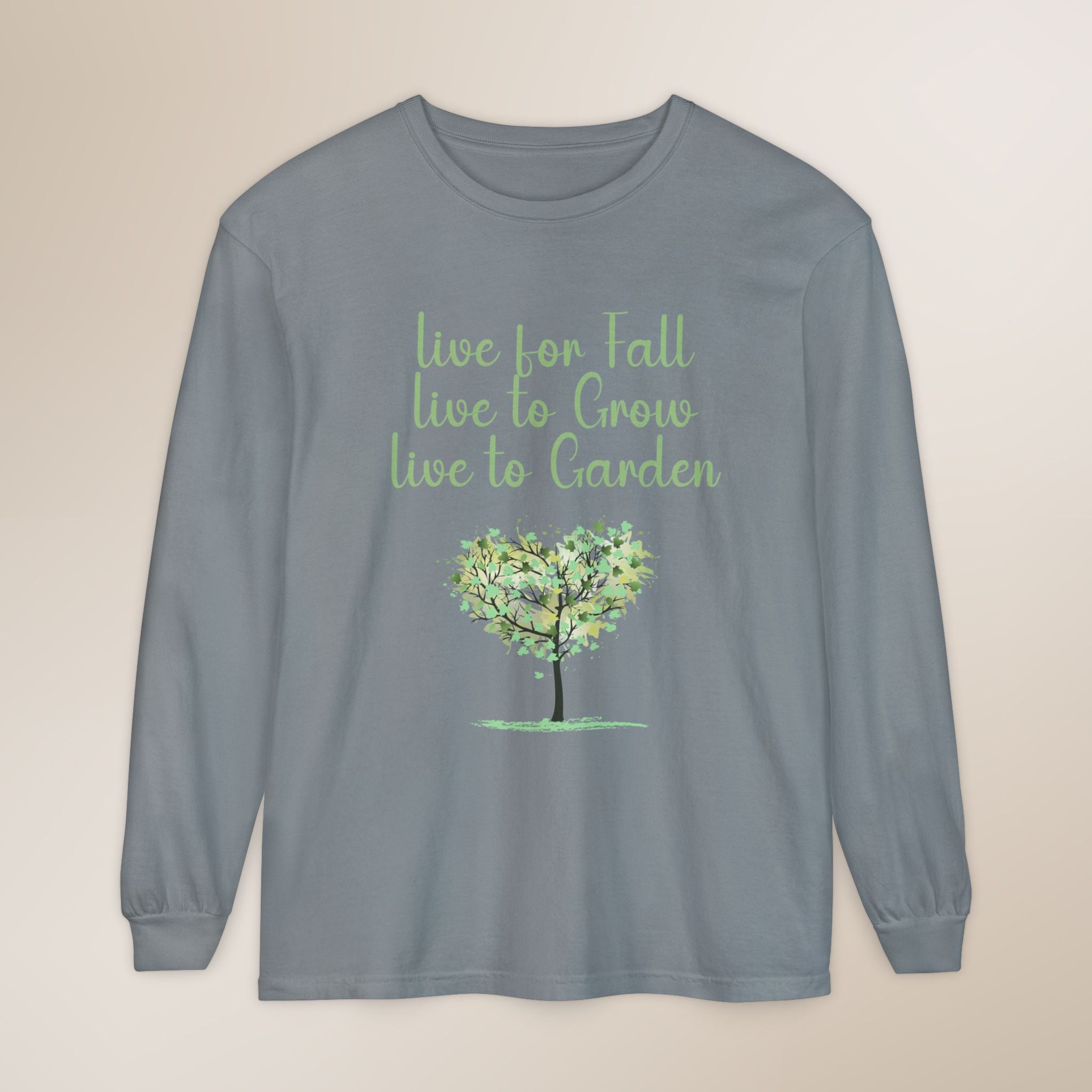 Gray long-sleeve shirt with green tree graphic and text on a beige background