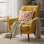 Yellow armchair with a floral pillow and blanket in a cozy living room setting.