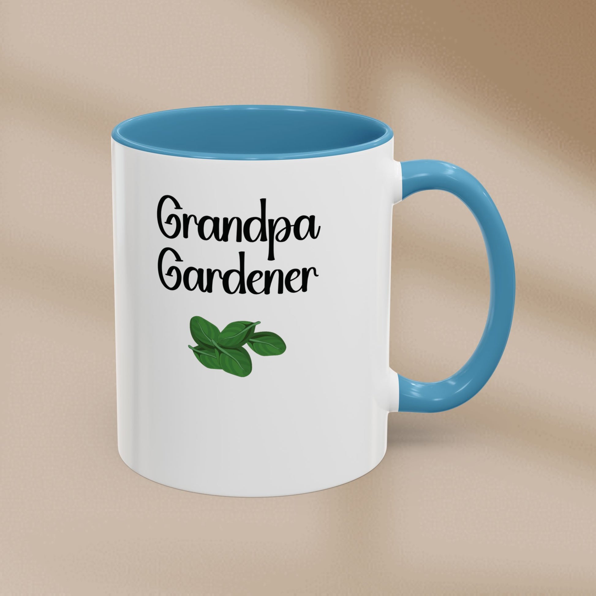Mug with 'Grandpa Gardener' text and leaf illustration on a beige background