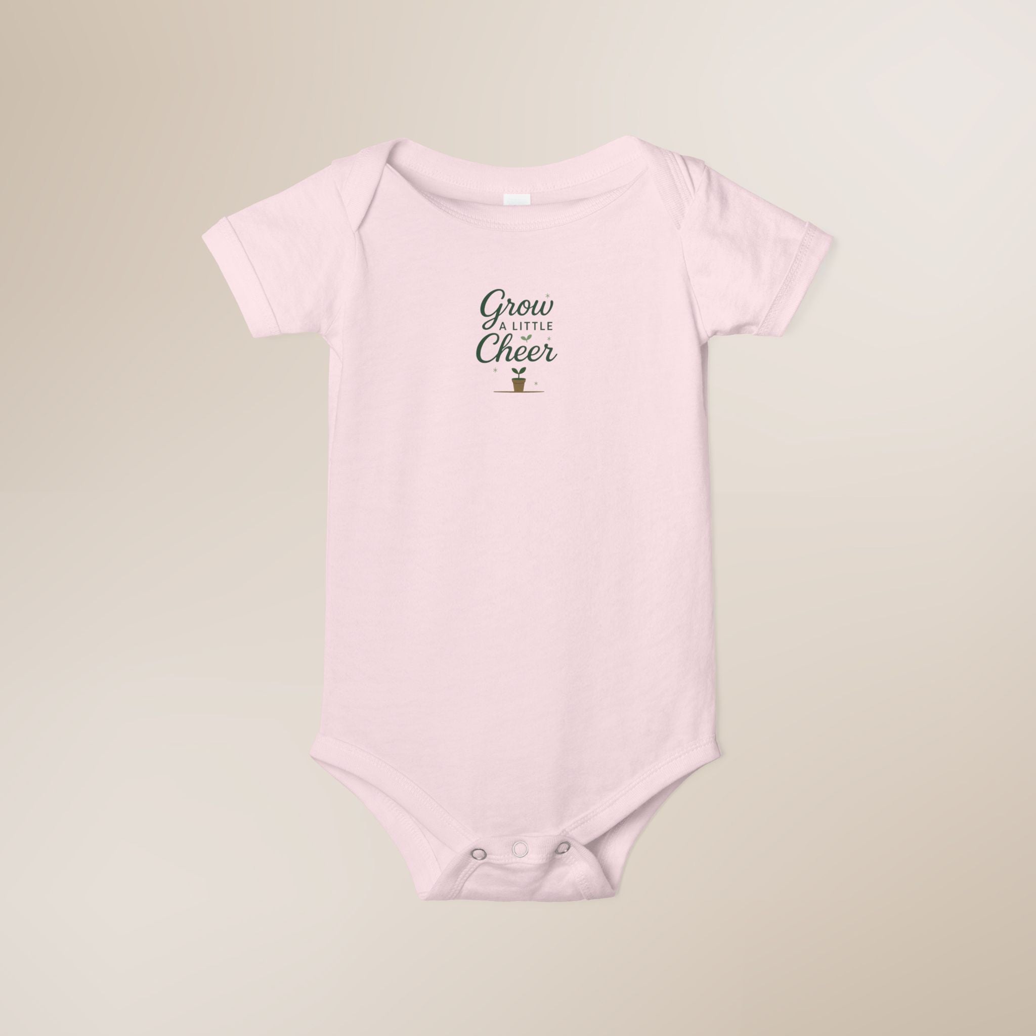 Pink baby onesie with text on a beige background