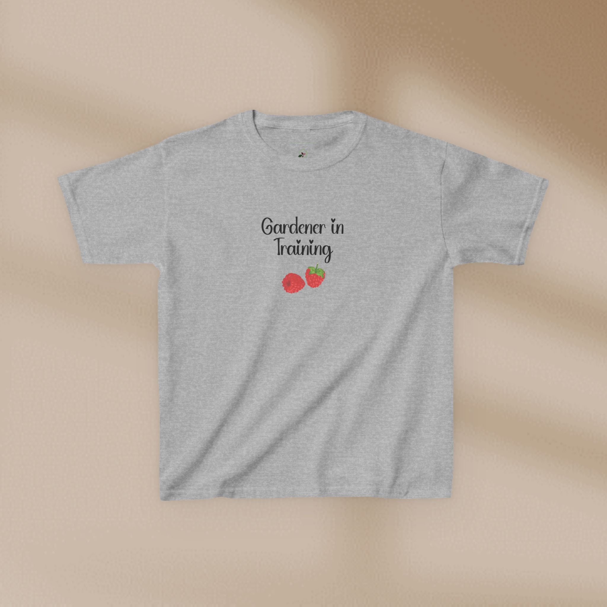 Gray t-shirt with 'Gardener in Training' text and strawberry graphics on a beige background