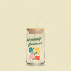 Glass tumbler with bamboo lid and straw featuring 'Mommy Gardener' text and floral designs on a white background.