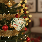 Decorative heart ornament with floral pattern on a Christmas tree with red and gold ornaments.