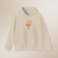 Beige hoodie with a tree graphic and text on a beige background