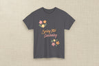 Green t-shirt with 'Spring Into Gardening' text and floral designs on a white background