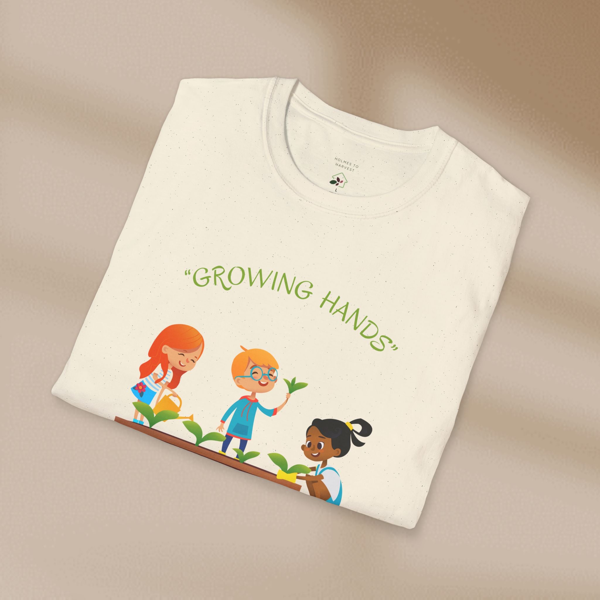Folded t-shirt with 'Growing Hands' illustration on a beige background