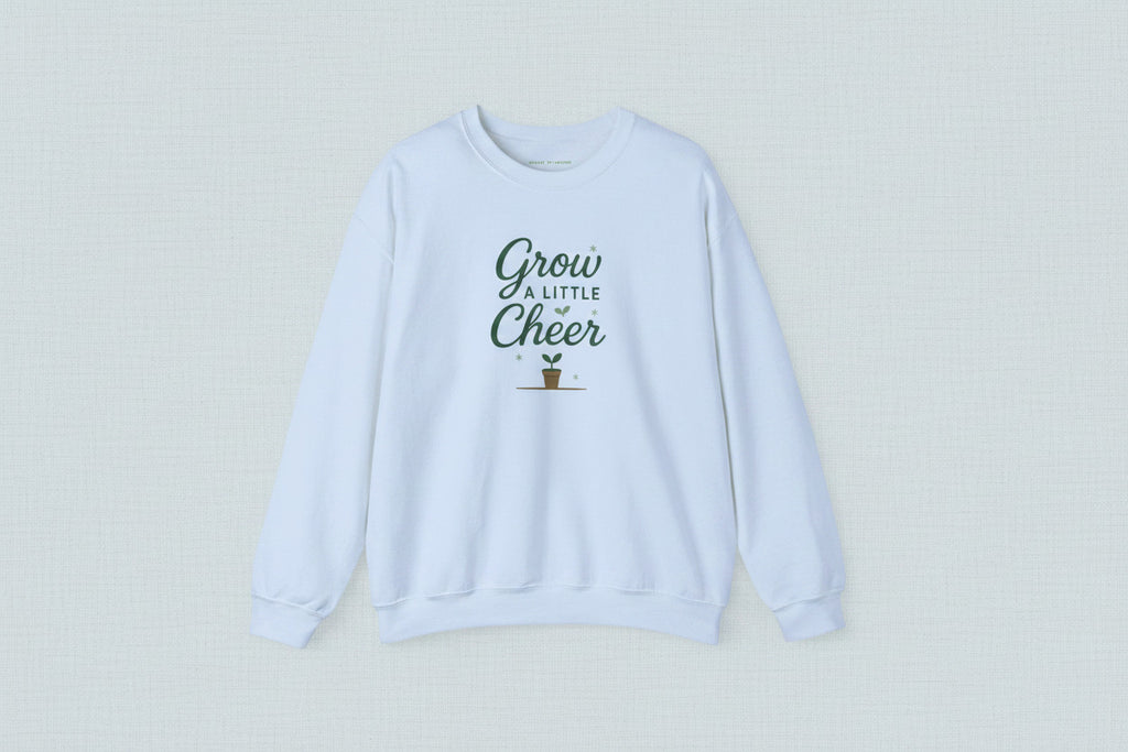 Light blue sweatshirt with 'Grow a Little Cheer' text on a white background