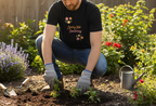 Person gardening in a colorful garden wearing a black t-shirt with text and graphics.