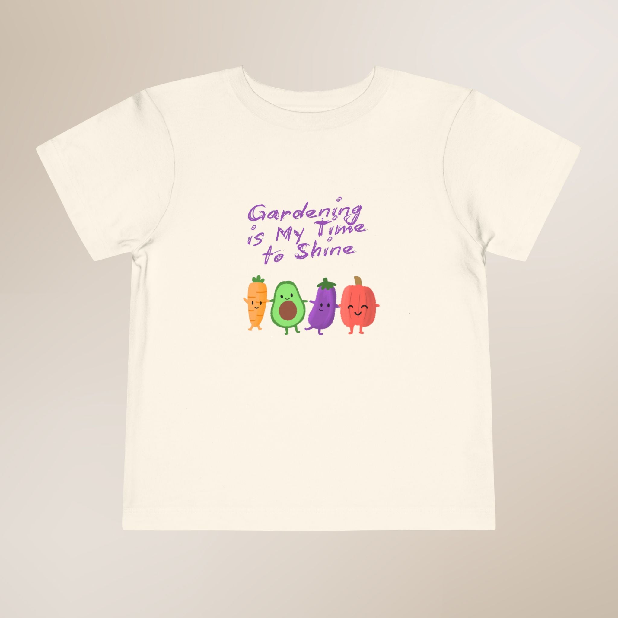 White t-shirt with colorful vegetable graphics and text on a beige background