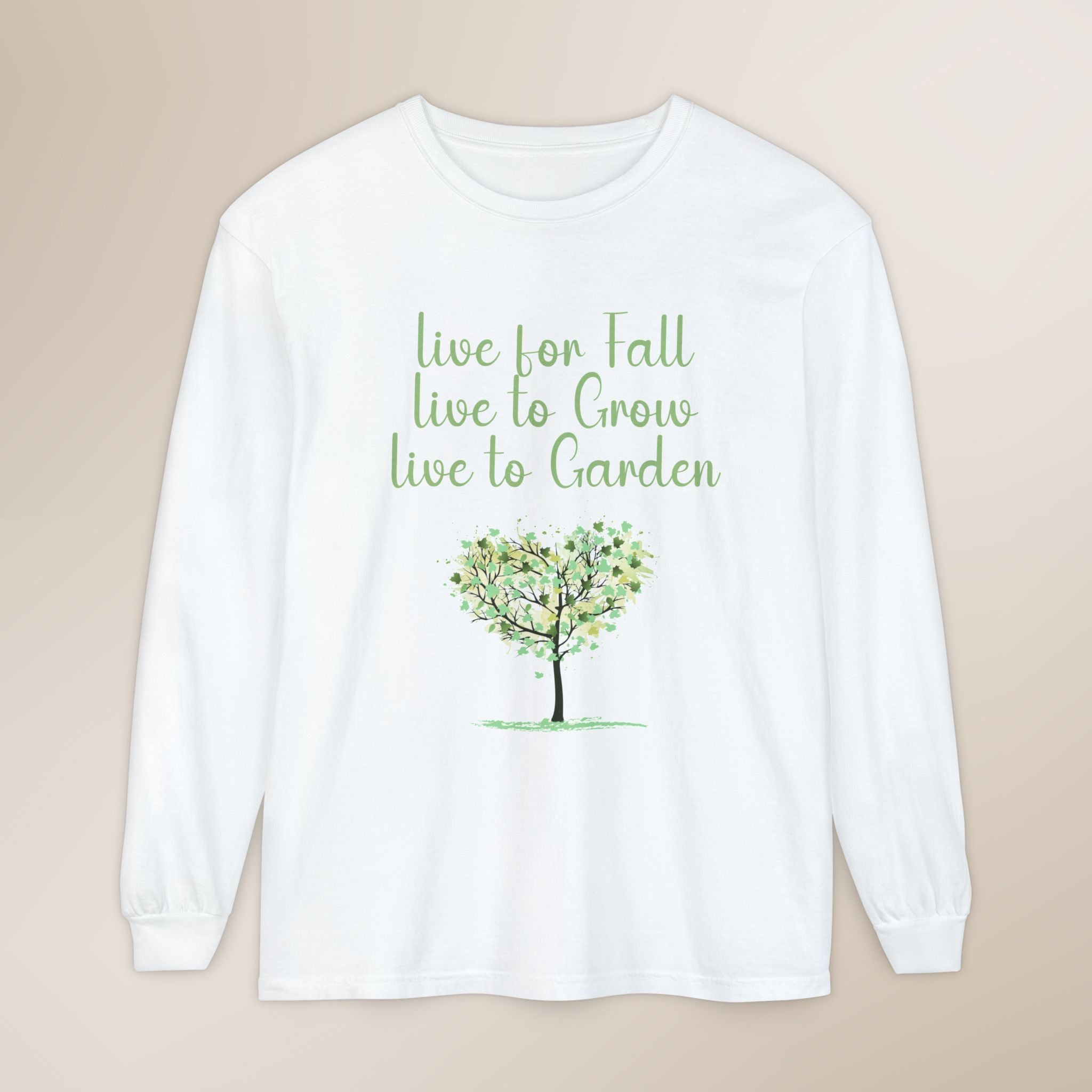 White long-sleeve shirt with green text and tree graphic on a beige background