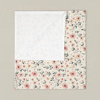 Floral patterned blanket with white border on a white background