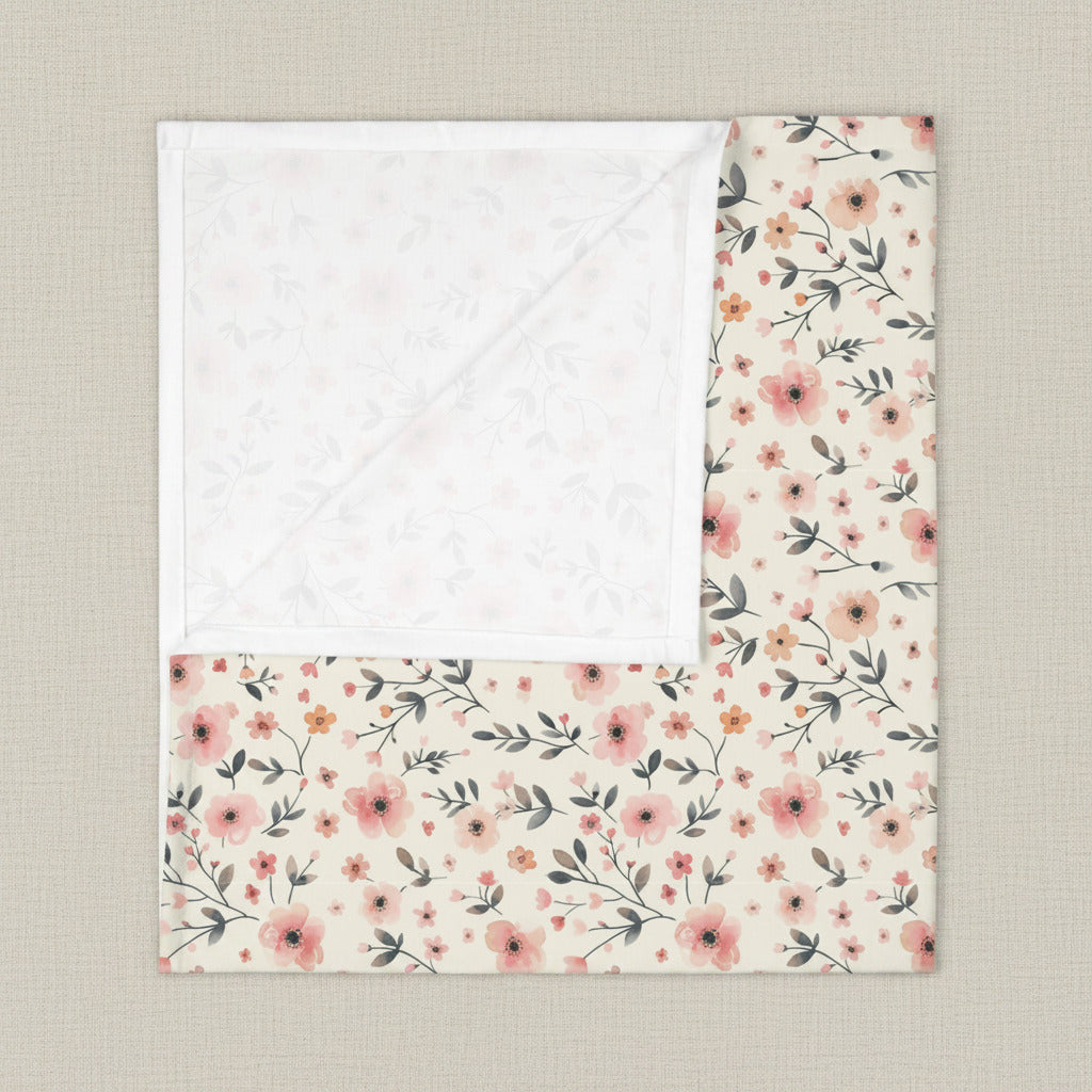 Floral patterned blanket with white border on a white background