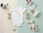 Baby clothing and items including a onesie, shoes, blocks, and a toy on a pastel background