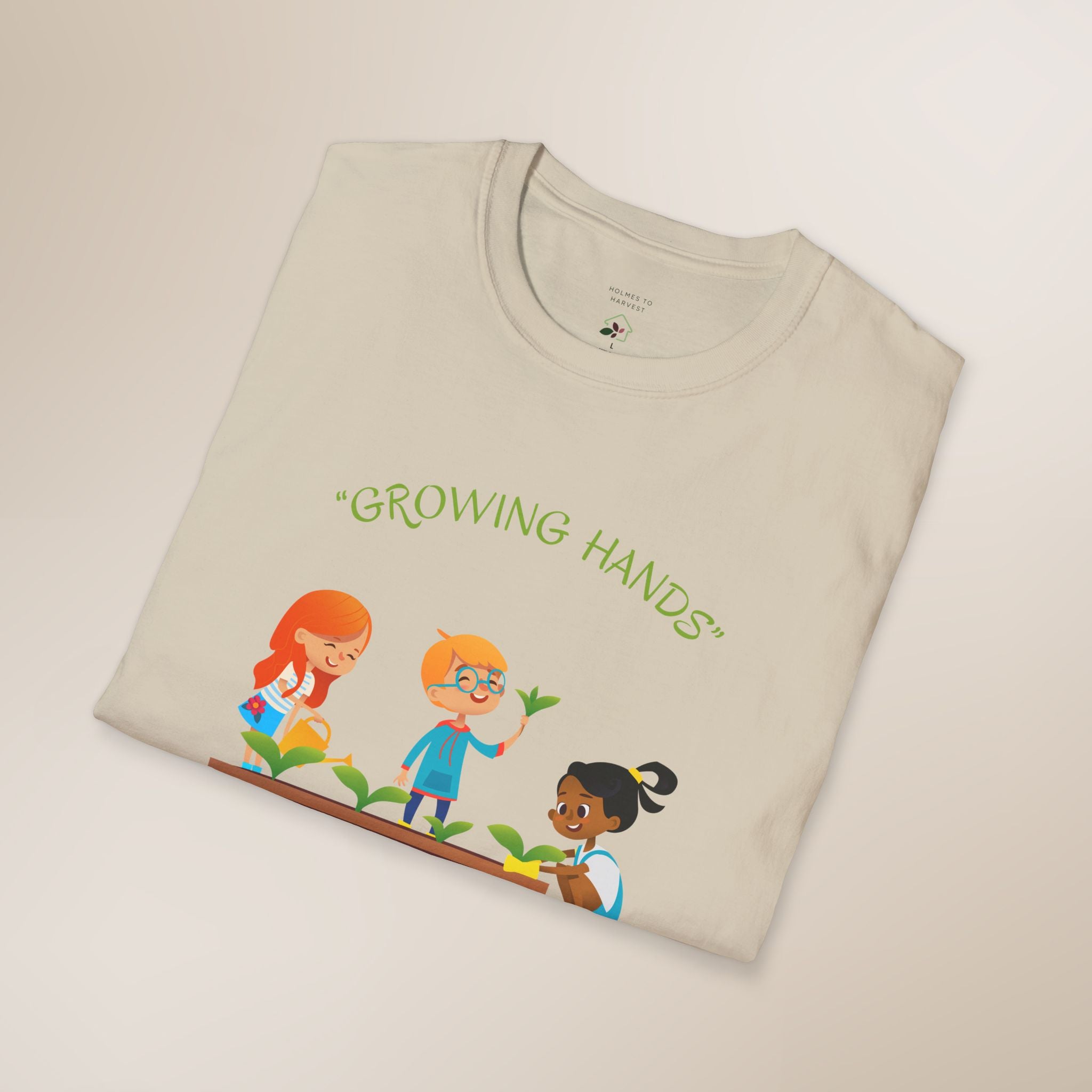 Folded beige t-shirt with 'Growing Hands' design on a light background