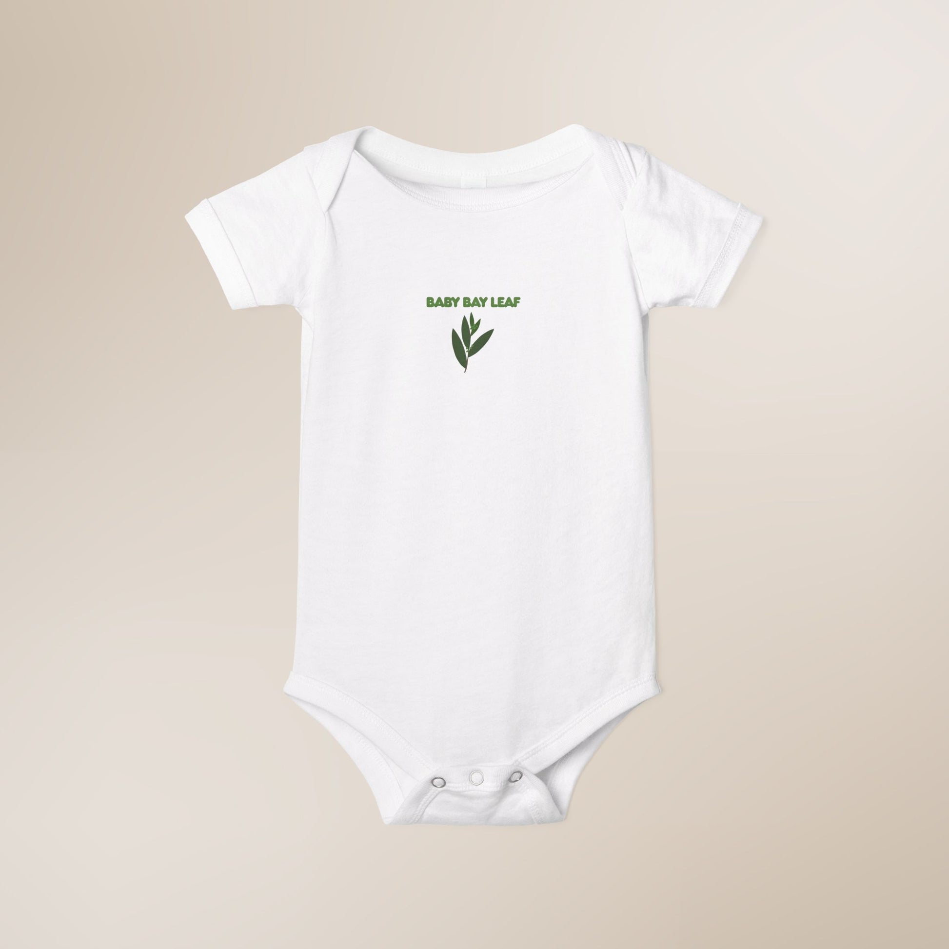 White baby onesie with 'Baby Bay Leaf' text and leaf design on a beige background