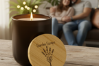Candle with wooden lid labeled 'Garden Escape' on a table, with a blurred background of people sitting on a couch.