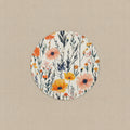 Round floral coaster with orange and pink flowers on a white background