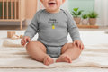 Baby wearing a gray 'Baby Gardener' onesie sitting on a blanket.
