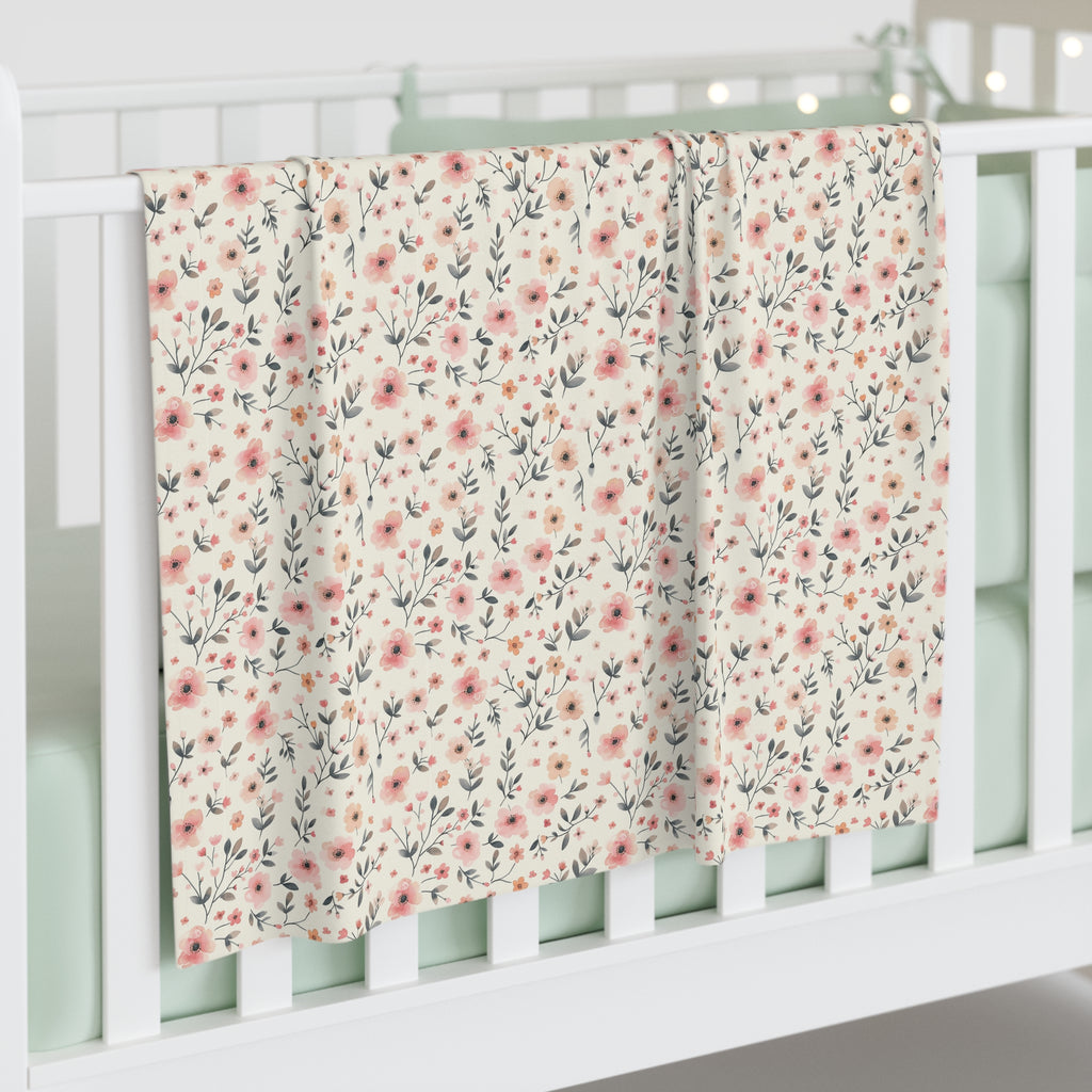 Floral patterned blanket draped over a crib